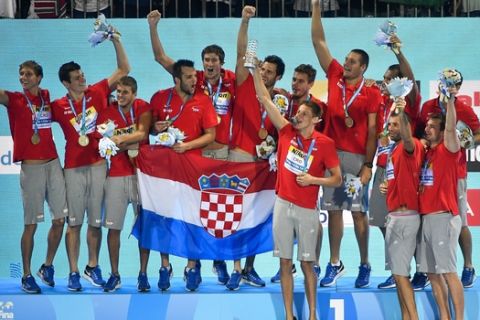 Players of Croatia celebrate on the podium after they won the gold in the men's water polo final match Hungary vs Croatia at the 17th FINA Swimming World Championships in Hajos Alfred National Swimming Pool in Budapest, Hungary, Saturday, July 29, 2017. (Zsolt Czegledi/MTI via AP)