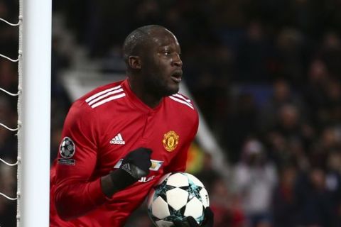 Manchester United's Romelu Lukaku celebrates after scoring his team first goal as CSKA's goalkeeper Igor Akinfeev, left, stands near the gates during the Champions League group A soccer match between Manchester United and CSKA Moscow in Manchester, England, Tuesday, Dec. 5, 2017. (AP Photo/Dave Thompson)