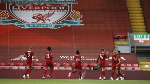 Liverpool's Trent Alexander-Arnold, right, celebrates after scoring the opening goal during the English Premier League soccer match between Liverpool and Crystal Palace at Anfield Stadium in Liverpool, England, Wednesday, June 24, 2020. (Phil Noble/Pool via AP)
