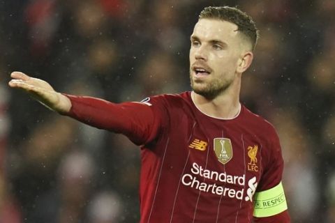 Liverpool's Jordan Henderson gives instructions during a second leg, round of 16, Champions League soccer match between Liverpool and Atletico Madrid at Anfield stadium in Liverpool, England, Wednesday, March 11, 2020. (AP Photo/Jon Super)