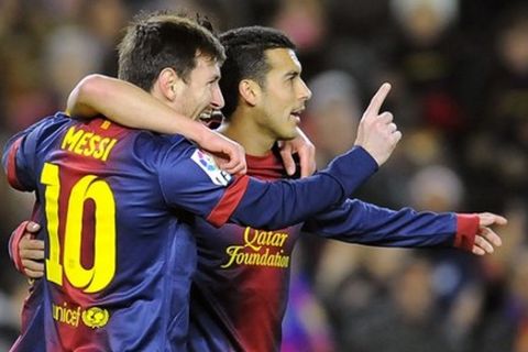 Barcelona's Lionel Messi from Argentina, left, celebrates with his fellow teammate Pedro after scoring against Osasuna during their Spanish League soccer match, at Camp Nou stadium in Barcelona, Spain, Sunday, Jan. 27, 2013. Barcelona won the match 5-1. (AP Photo/Alvaro Barrientos)