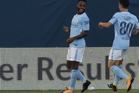 Manchester City forward Raheem Sterling, left, celebrates with Phil Foden (80) after scoring a goal against Tottenham Hotspur during the second half of an International Champions Cup match Saturday, July 29, 2017, in Nashville, Tenn. (AP Photo/Mark Zaleski)