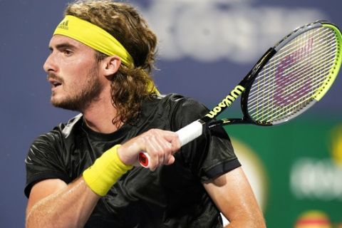 Stefanos Tsitsipas, of Greece, returns a shot from Lorenzo Sonego, of Italy, during the Miami Open tennis tournament, Tuesday, March 30, 2021, in Miami Gardens, Fla. (AP Photo/Wilfredo Lee)