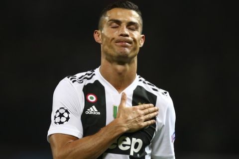 Juventus forward Cristiano Ronaldo gestures at the end of the Champions League group H soccer match between Manchester United and Juventus at Old Trafford, Manchester, England, Tuesday, Oct. 23, 2018. (AP Photo/Dave Thompson)