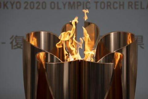 The Olympic Flame burns during a ceremony in Fukushima City, Japan, Tuesday, March 24, 2020. The Tokyo Olympic torch relay will start Thursday as planned in northeastern Fukushima prefecture, but with no torch, no torchbearers, no public, and little ceremony. (AP Photo/Jae C. Hong)