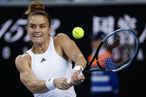Maria Sakkari of Greece plays a backhand return to Zheng Qinwen of China during their second round match at the Australian Open tennis championships in Melbourne, Australia, Wednesday, Jan. 19, 2022. (AP Photo/Hamish Blair)