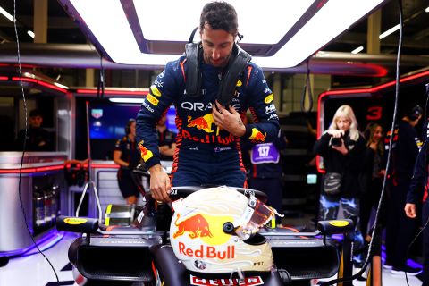 NORTHAMPTON, ENGLAND - JULY 11:  Daniel Ricciardo of Australia climbs into the (3) Oracle Red Bull Racing RB19 in the garage as he prepares to drive during Formula 1 testing at Silverstone Circuit on July 11, 2023 in Northampton, England. (Photo by Mark Thompson/Getty Images)