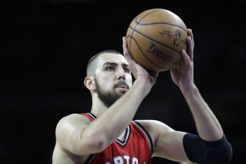Toronto Raptors center Jonas Valanciunas shoots a free throw during the second half of an NBA basketball game against the Detroit Pistons, Wednesday, April 5, 2017, in Auburn Hills, Mich. (AP Photo/Carlos Osorio)