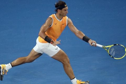 Spain's Rafael Nadal makes a forehand return to Greece's Stefanos Tsitsipas during their semifinal at the Australian Open tennis championships in Melbourne, Australia, Thursday, Jan. 24, 2019. (AP Photo/Kin Cheung)