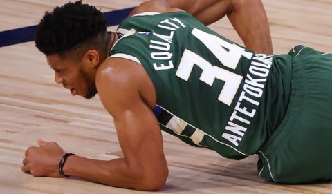 Milwaukee Bucks' Giannis Antetokounmpo reacts after being fouled by the Dallas Mavericks during an NBA basketball game Saturday, Aug. 8, 2020, in Lake Buena Vista, Fla. (Kevin C. Cox/Pool Photo via AP)