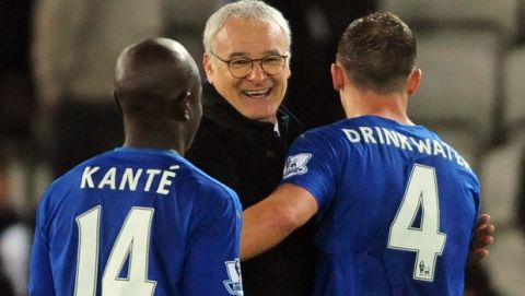 Leicester manager Claudio Ranieri congratulates Daniel Drinkwater, right, and Ngolo Kante, left, after the English Premier League soccer match between Leicester City and Newcastle United at the King Power Stadium in Leicester, England, Monday, March 14, 2016. (AP Photo/Rui Vieira)