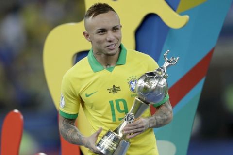 Brazil's Everton holds his top scorer trophy after his team's 3-1 defeat of Peru in the final match of the Copa America at Maracana stadium in Rio de Janeiro, Brazil, Sunday, July 7, 2019. (AP Photo/Silvia Izquierdo)