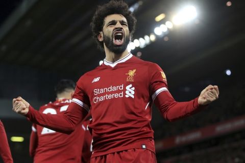 Liverpool's Mohamed Salah celebrates scoring his side's second goal against Leicester City during the English Premier League soccer match at Anfield, Liverpool, England, Saturday Dec. 30, 2017. (Peter Byrne/PA via AP)