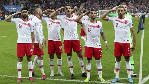 Turkey's players salute as they celebrated a goal against France during the Euro 2020 group H qualifying soccer match between France and Turkey at Stade de France at Saint Denis, north of Paris, France, Monday, Oct. 14, 2019. (AP Photo/Thibault Camus)