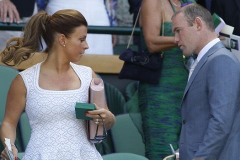 Soccer player Wayne Rooney, right, and his wife Coleen Rooney, left, arrive prior to the Men's singles final match at the All England Lawn Tennis Championships in Wimbledon, London, Sunday, July 7, 2013. (AP Photo/Kirsty Wigglesworth)