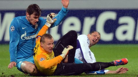 FC Zenit St Petersburg's player Nicolas Lombaerts (L), goalkeeper  Vyacheslav Malafeev (C) and RSC Anderlecht's player Milan Jovanovic (R) are in action during their UEFA Champions League group C football match in Saint-Petersburg on October 24, 2012. AFP PHOTO / KIRILL KUDRYAVTSEV        (Photo credit should read KIRILL KUDRYAVTSEV/AFP/Getty Images)