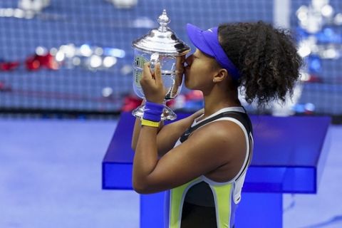 Naomi Osaka, of Japan, holds up the championship trophy after defeating Victoria Azarenka, of Belarus, in the women's singles final of the US Open tennis championships, Saturday, Sept. 12, 2020, in New York. (AP Photo/Seth Wenig)