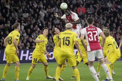 Ajax's Brian Brobbey heads the ball as hs is closed down by Glimt players during the Europa Conference League knockout round play-off first leg soccer match between Ajax and Bodo Glimt in Amsterdam, the Netherlands, Thursday, Feb. 15, 2024. (AP Photo/Patrick Post)