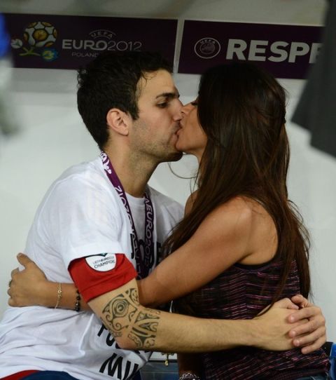 Spanish midfielder Cesc Fabregas kisses his girlfriend after winning the Euro 2012 football championships final match Spain vs Italy on July 1, 2012 at the Olympic Stadium in Kiev. AFP PHOTO / FRANCK FIFE        (Photo credit should read FRANCK FIFE/AFP/GettyImages)