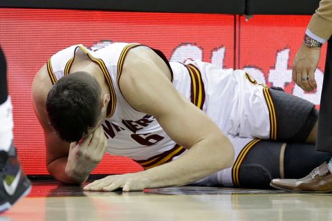 Cleveland Cavaliers' Andrew Bogut (6) grimaces after getting hurt in the first half of an NBA basketball game against the Miami Heat, Monday, March 6, 2017, in Cleveland. (AP Photo/Tony Dejak)
