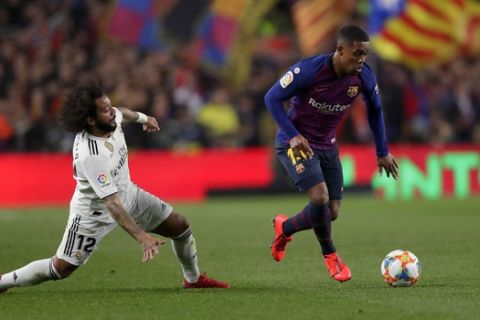 Barcelona forward Malcom, right, and Real defender Marcelo run for the ball during the Copa del Rey semifinal first leg soccer match between FC Barcelona and Real Madrid at the Camp Nou stadium in Barcelona, Spain, Wednesday Feb. 6, 2019. (AP Photo/Manu Fernandez)