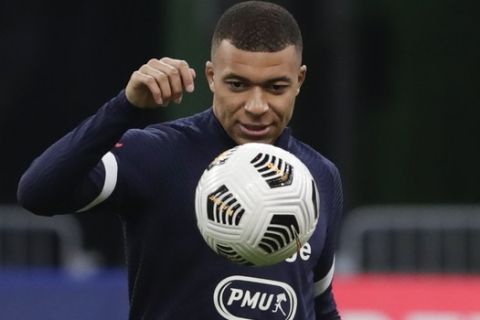 France's Kylian Mbappe warms up before the World Cup 2022 group D qualifying soccer match between France and Ukraine at the Start de de France stadium, in Saint Denis, north of Paris, Wednesday, March 24, 2021. (AP Photo/Thibault Camus)