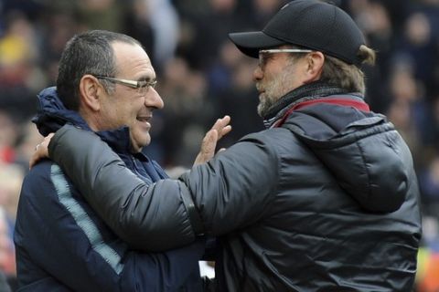 Chelsea manager Maurizio Sarri, left, speaks with Liverpool manager Juergen Klopp before the English Premier League soccer match between Liverpool and Chelsea at Anfield stadium in Liverpool, England, Sunday, April 14, 2019. (AP Photo/Rui Vieira)