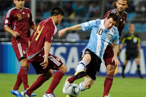 Argentina's Lionel Messi (2nd R) vies with Venezuela's Franklin Lucena and Oswaldo Vizcarrondo (R) during a Brazil 2014 World Cup South American qualifier match, at the Jose Antonio Anzoategui olympic stadium in Puerto La Cruz, Venezuela, on October 11, 2011. AFP PHOTO /Luis Robayo (Photo credit should read LUIS ROBAYO/AFP/Getty Images)