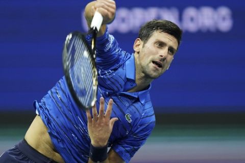 Novak Djokovic, of Serbia, serves to Stan Wawrinka, of Switzerland, during round four of the U.S. Open tennis championships Sunday, Sept. 1, 2019, in New York. (AP Photo/Eduardo Munoz Alvarez)