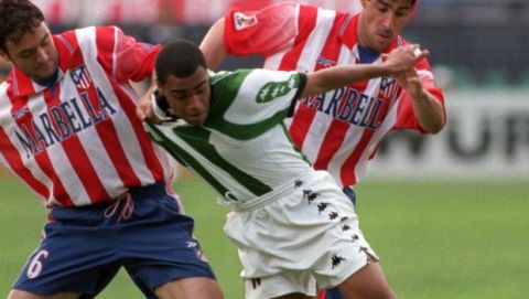 Betis' Brazilian player Denilson, centre is held back by Athletico Madrid players Santi, left and Oscar Mena of Argentina during a league soccer match in Madrid Sunday May 9, 1999. Santi was sent off for the foul on Denilson and Betis scored from the penalty spot, going on to win the game 3-2. (AP Photo/Zaheeruddin Abdulah)