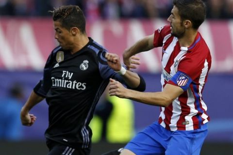 Atletico Madrid's Gabriel Fernandez, right, tries to stop Real Madrid's Cristiano Ronaldo during the Champions League semifinal second leg soccer match between Atletico Madrid and Real Madrid at the Vicente Calderon stadium in Madrid, Wednesday, May 10, 2017. (AP Photo/Francisco Seco)