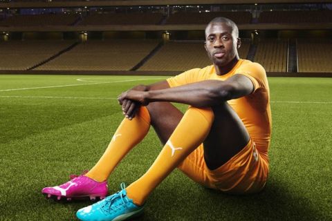 Yaya Touré in the 2014 Ivory Coast Home Kit that features PUMA's PWR ACTV Technology 
