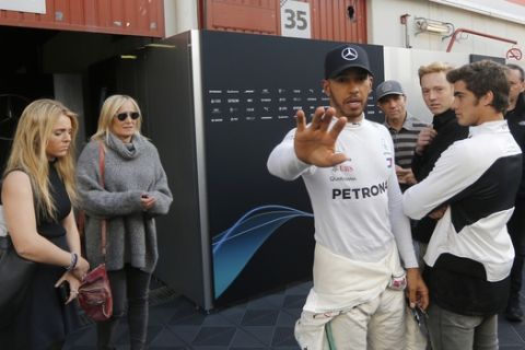 Mercedes driver Lewis Hamilton of Britain gestures in the paddock during a Formula One pre-season testing session in Montmelo, outside Barcelona, Spain, Friday, March 9, 2018. (AP Photo/Manu Fernandez)