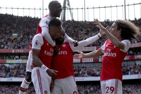 Arsenal's Pierre-Emerick Aubameyang, left, celebrates scoring his side's first goal of the game with teammates, during the English Premier League soccer match between Arsenal and Burnley FC, at The Emirates Stadium, in London, Saturday, Aug. 17, 2019. (Yui Mok/PA via AP)