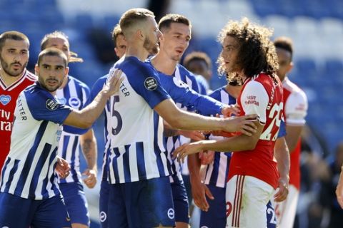 Brighton's Adam Webster, center, gets between Brighton's Neal Maupay, center left, and Arsenal's Matteo Guendouzi during an argument at the end of the English Premier League soccer match between Brighton & Hove Albion and Arsenal at the AMEX Stadium in Brighton, England, Saturday, June 20, 2020. (Richard Heathcote/Pool via AP)