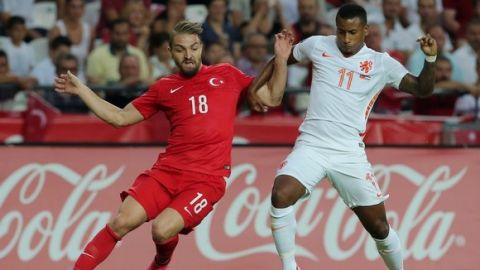 Netherlands' forward Luciano Narsingh (R) vies for the ball with Turkey's defender Caner Erkin (L) during the Euro 2016 qualifying football match between Turkey and Netherlands at the Arena Stadium in Konya, on September 6, 2015 in Konya. AFP PHOTO / STRINGER        (Photo credit should read STR/AFP/Getty Images)
