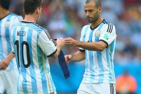 PORTO ALEGRE, BRAZIL - JUNE 25:  Lionel Messi of Argentina ands off the captain's armband to teammate Javier Mascherano as he exits the game during the 2014 FIFA World Cup Brazil Group F match between Nigeria and Argentina at Estadio Beira-Rio on June 25, 2014 in Porto Alegre, Brazil.  (Photo by Jeff Gross/Getty Images)
