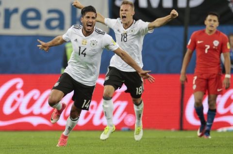 Germany's Emre Can, left, and Joshua Kimmich celebrate their 1-0 win, at the end of the Confederations Cup final soccer match between Chile and Germany, at the St.Petersburg Stadium, Russia, Sunday July 2, 2017. (AP Photo/Ivan Sekretarev)
