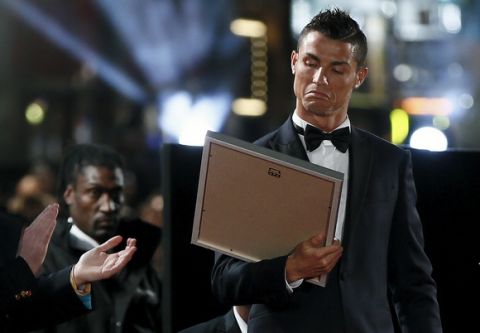 Soccer player Cristiano Ronaldo reacts as he receives a certificate on the red carpet at the world premiere of "Ronaldo" at Leicester Square in London, Britain November 9, 2015. REUTERS/Stefan Wermuth