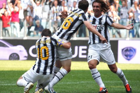 Juventus' Swiss player Stephan Lichtsteiner (C) is congratulated by teammates Alessandro Del Piero (L) and Andrea Pirlo after he scored a goal against Parma during their serie A football match at the Delle Alpi stadium in Turin on September 11, 2011.  AFP PHOTO / FABIO MUZZI (Photo credit should read FABIO MUZZI/AFP/Getty Images)