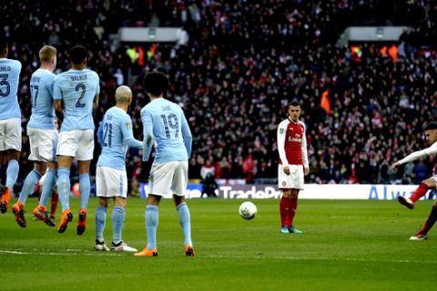 Arsenal's Aaron Ramsey, right takes free kick at goal during the English League Cup Final between Arsenal and Manchester City at Wembley stadium in London, Sunday, Feb. 25, 2018.(AP Photo/Tim Ireland)