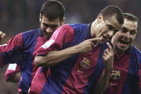F.C. Barcelona's Brazilian forward Rivaldo, center, celebrates with teamates Pepi Guardiola, left, and Sergi after scoring a goal against Real Madrid in a Spanish league soccer match in Real's Santiago Bernabeu stadium in Madrid, Spain, Saturday, March 3 2001. The match ended 2-2. (AP Photo/Zaheeruddin Abdullah)