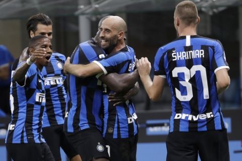 Inter Milan's Borja Valero, second from right, celebrates with his teammates after scoring his side's third goal during the Serie A soccer match between Inter Milan and Sassuolo at the San Siro Stadium, in Milan, Italy, Wednesday, June 24, 2020. (AP Photo/Luca Bruno)