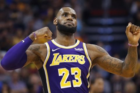 Los Angeles Lakers forward LeBron James (23) celebrates a basket against the Phoenix Suns during the second half of an NBA basketball game, Wednesday, Oct. 24, 2018, in Phoenix. (AP Photo/Matt York)
