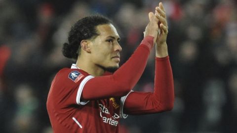 Liverpool's Virgil van Dijk applauds fans after the final whistle during the English FA Cup Third Round soccer match between Liverpool and Everton at Anfield in Liverpool, England, Friday, Jan. 5, 2018. (AP Photo/Rui Vieira)