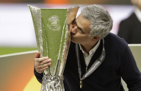 Manchester manager Jose Mourinho kisses the trophy after winning 2-0 during the soccer Europa League final between Ajax Amsterdam and Manchester United at the Friends Arena in Stockholm, Sweden, Wednesday, May 24, 2017. (AP Photo/Michael Sohn)
