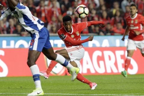 Benfica's Nelson Semedo, center, attempts a shot at goal during a Portuguese league soccer match between Benfica and FC Porto at the Luz stadium in Lisbon, Saturday, April 1, 2017. (AP Photo/Armando Franca)