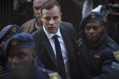 Oscar Pistorius, center, arrives at the High Court in Pretoria, South Africa Wednesday, July 6, 2016. A South African judge is expected to announce Oscar Pistorius' sentence for murdering girlfriend Reeva Steenkamp in his home on Valentine's Day 2013. (AP Photo/Shiraaz Mohamed)