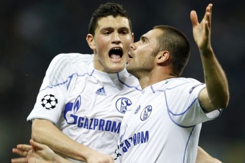 Schalke 04's Edu (R) celebrates with his team mate Kyriakos Papadopoulos after scoring against Inter Milan during their first leg of the Champions League quarter-final soccer match at the San Siro stadium in Milan April 5, 2011. REUTERS/Stefano Rellandini  (ITALY - Tags: SPORT SOCCER)