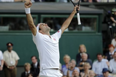 Switzerland's Roger Federer celebrates defeating Spain's Rafael Nadal during a men's singles semifinal match on day eleven of the Wimbledon Tennis Championships in London, Friday, July 12, 2019. (AP Photo/Ben Curtis)
